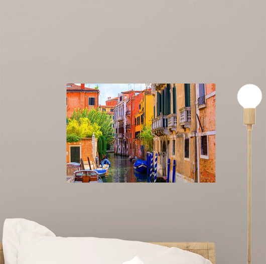 multicolored houses astride one of Venetian canals. 