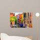 multicolored houses astride one of Venetian canals. 
