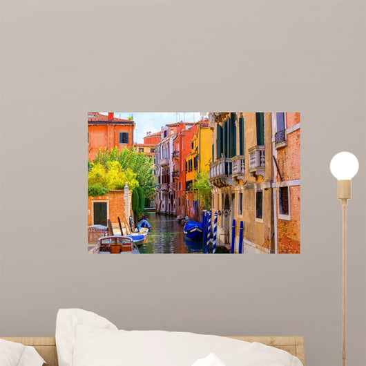 multicolored houses astride one of Venetian canals. 