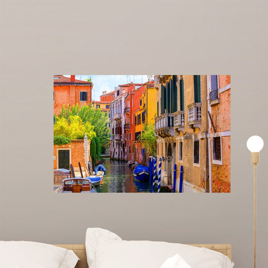 multicolored houses astride one of Venetian canals. 