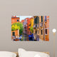 multicolored houses astride one of Venetian canals. 