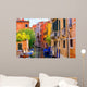 multicolored houses astride one of Venetian canals. 