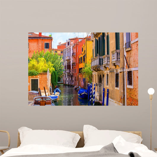 multicolored houses astride one of Venetian canals. 