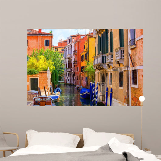 multicolored houses astride one of Venetian canals. 