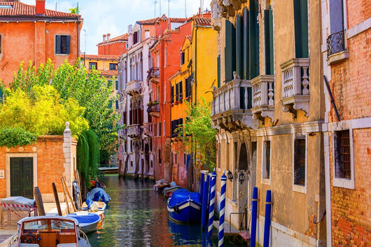 multicolored houses astride one of Venetian canals. 