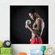 Confident young man shirtless portrait training with dumb-bell a Wall Mural