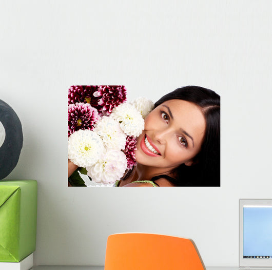 Smiling woman with flowers. Close up. Wall Mural