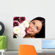 Smiling woman with flowers. Close up. Wall Mural