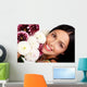 Smiling woman with flowers. Close up. Wall Mural