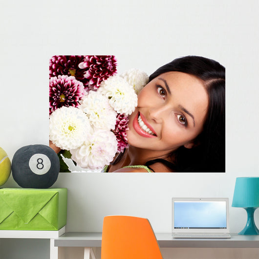 Smiling woman with flowers. Close up. Wall Mural