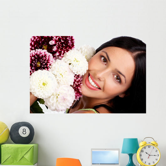Smiling woman with flowers. Close up. Wall Mural