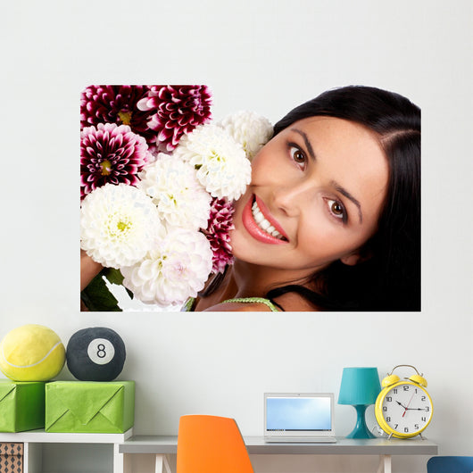 Smiling woman with flowers. Close up. Wall Mural