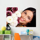Smiling woman with flowers. Close up. Wall Mural
