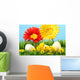 Easter chicks in the grass with flowers against a blue sky Wall Mural