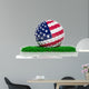 Golf ball with flag of USA on green grass 