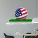 Golf ball with flag of USA on green grass 