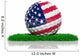 Golf ball with flag of USA on green grass 