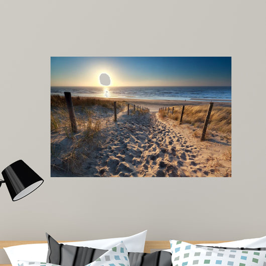 sunshine over path to beach in North sea 