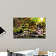 beautiful waterfall comes out of a huge rock in the forest Wall Mural