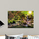 beautiful waterfall comes out of a huge rock in the forest Wall Mural