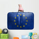 Tourist hand holding vintage leather travel bag with flag of Eur 