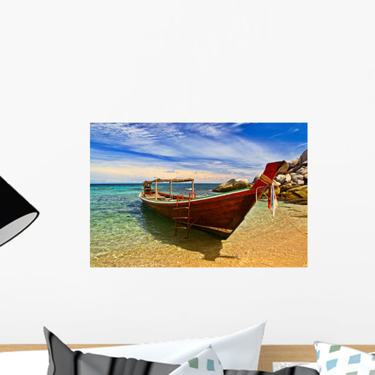 Longtail boat in tranquil bay Wall Mural