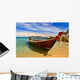 Longtail boat in tranquil bay Wall Mural