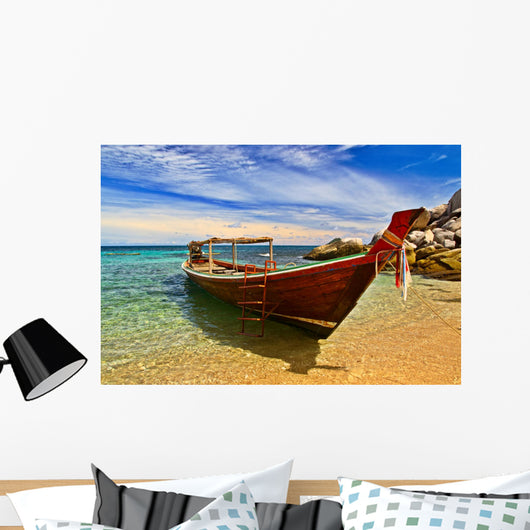 Longtail boat in tranquil bay Wall Mural