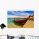 Longtail boat in tranquil bay Wall Mural