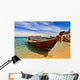 Longtail boat in tranquil bay Wall Mural