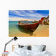 Longtail boat in tranquil bay Wall Mural