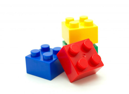 Plastic building blocks on white background 
