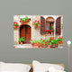 Italian house front with colorful potted flowers Wall Mural