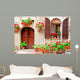 Italian house front with colorful potted flowers Wall Mural