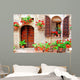 Italian house front with colorful potted flowers Wall Mural