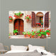 Italian house front with colorful potted flowers Wall Mural