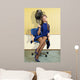 young woman sitting under a hairdryier with roller on head 