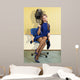 young woman sitting under a hairdryier with roller on head 