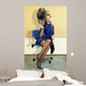 young woman sitting under a hairdryier with roller on head 