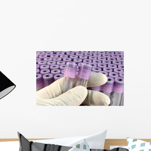 researcher with rubber glove sorts research test tubes Wall Mural