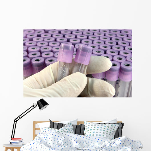 researcher with rubber glove sorts research test tubes Wall Mural