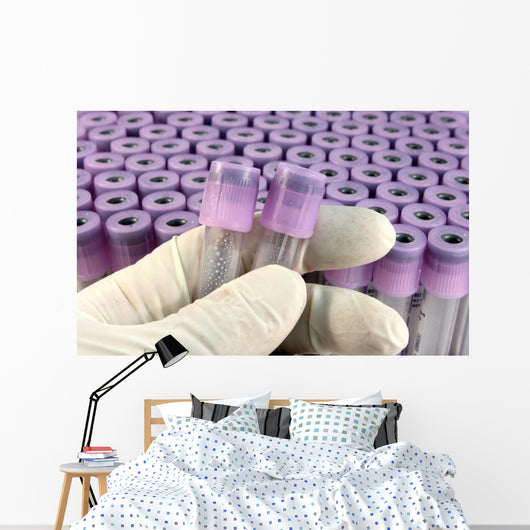 researcher with rubber glove sorts research test tubes Wall Mural