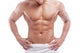 Muscular man in towel, isolated on white 
