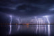Thunderstorm and lightnings in night over a lake with reflaction 