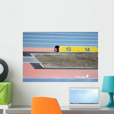 Long Jump Sand Pit Wall Mural shown on a wall