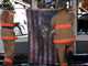 Firemen Raising American Flag