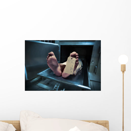 Feet on a morgue table with toe tag with dramatic lighting Wall Mural