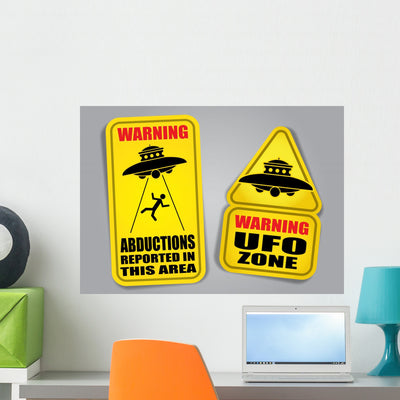 Warning Ufo Signs shown on a wall
