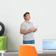 Asian man reading a book looking up with day dreaming Wall Decal