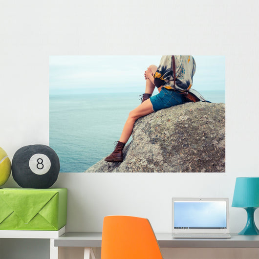 Young Woman Sitting Rock Wall Mural
